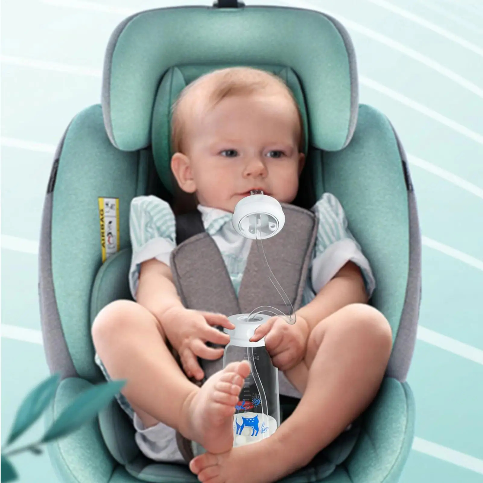 A baby sitting in a mint green and gray infant car seat, holding a clear bottle with a white cap. The baby is wearing a light blue and white striped shirt.